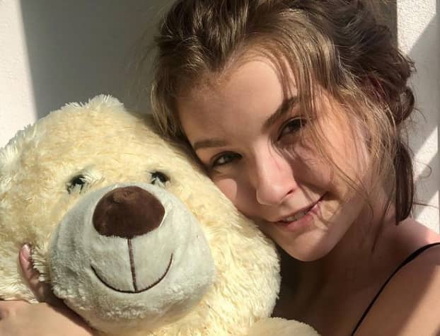 Mia Melano with a teddy bear