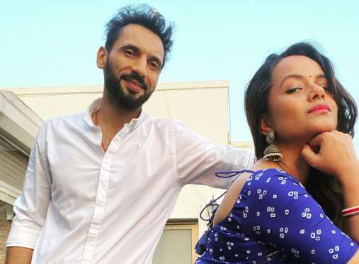 Nidhi Moony Singh Pathak and her husband Punit Pathak is smiling 