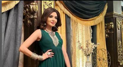 Parull Chaudhry in a green dress 